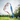 A Julbo Eyewear Neoprene Sunglass Strap in blue and red holds a pair of sunglasses that appear to float outdoors, surrounded by trees and sunlight. #color_julbo-neoprene-sunglass-strap-star-spangled