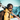 A smiling person wearing Julbo-usa Shadow frameless ski goggles and a helmet carries skis on their shoulder, framed by snowy mountain scenery.