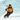 A skier in a yellow jacket and black pants speeds downhill, wearing Julbo-usa's Shadow—sleek frameless ski goggles—amid the snowy mountain landscape.