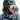 Person wearing a black helmet and reflective goggles with a blurred background