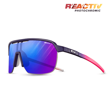Julbo Eyewear Frequency sport sunglasses feature a shield-style navy and pink frame, blue-purple mirrored photochromic lenses, full coverage, vented design, and REACTIV branding in the top right corner. #color_purple-pink-with-reactiv-1-3-high-contrast-lens