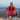 Man running on a mountain trail wearing an orange jacket and sunglasses.