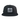The Né dans les Alpes Unstructured Hat by Julbo Eyewear is a black cap with a front patch featuring a mountain graphic, "Julbo 1888," and geographic coordinates—perfect for fans of alpine style. #color_né-dans-les-alpes-unstructured-hat-black