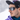 A man wearing Julbo-usa Camino photochromic sunglasses, a patterned cap, and a purple jacket stands outside in the snow.