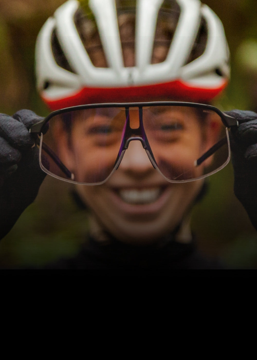Haley Batten holding a pair of black density sunglasses up to the camera