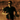 A person wearing sunglasses and a black shirt runs outdoors on a sunlit trail with a blurred background of dry grass.