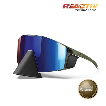Julbo Eyewear Edge Cover sunglasses feature blue mirrored lenses, an olive green frame, Reactiv Technology branding, and an adjustable nosepiece. Includes a display stand and Alpinist Mountain Standards Award badge. #color_army-black-with-reactiv-2-4-lens
