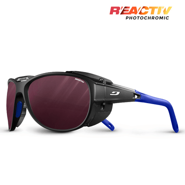The Julbo-usa Explorer 2.0 sunglasses feature black and blue frames with red photochromic, high-protection lenses, branded with Julbo and REACTIV Photochromic logos. #color_black-blue-with-reactiv-0-4-high-contrast-lens