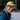 A man, outdoors in a snowy forest, smiles while wearing a yellow cap backward and Julbo Eyewear’s Explorer 2.0 RX mountaineering sunglasses with REACTIV photochromic lenses.