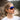 A person with braided hair wears Julbo Eyewear's Faster sunglasses with photochromic lenses and a white shirt, standing outdoors and looking slightly upward with a neutral expression.