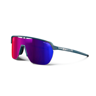 Julbo Eyewear’s Frequency sunglasses feature a shield-style design with a thin teal frame and large, angular, vented lenses in a pink-to-blue gradient for full coverage, shown on a white background. #color_blue-black-with-spectron-3-hd-lens