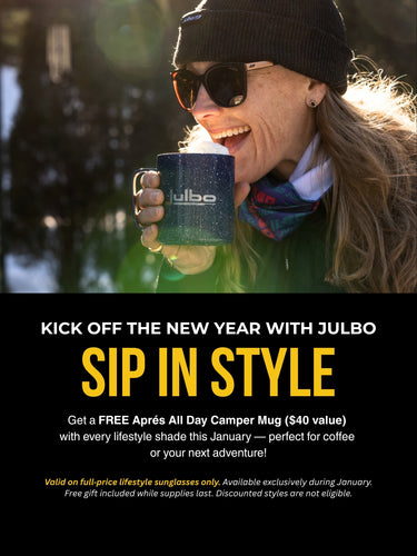 A woman wearing sunglasses and a beanie holds a Julbo mug outdoors, smiling in sunlight. Promotional text for a free mug offer is displayed below.