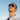 Man wearing reflective sunglasses against a clear blue sky