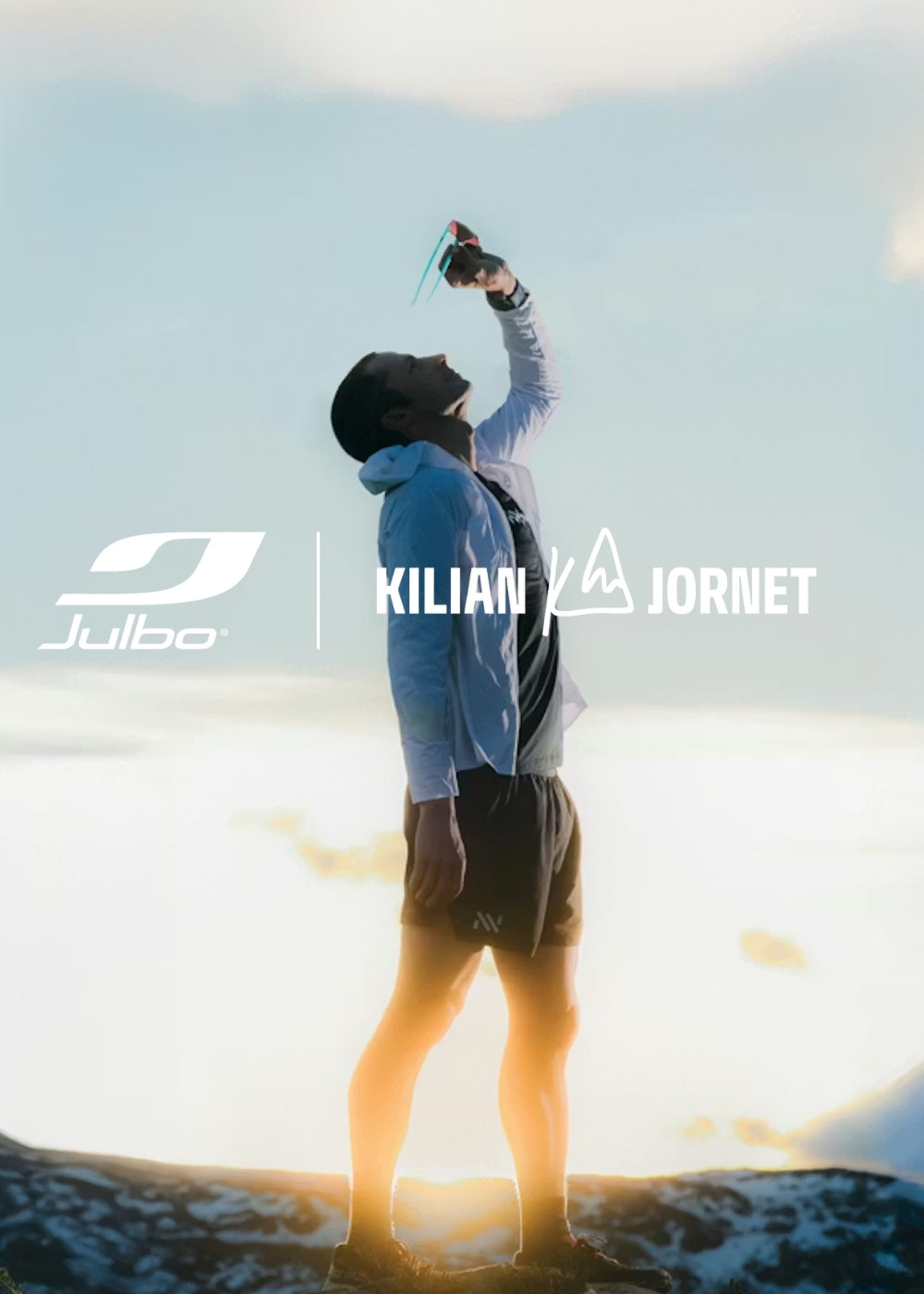 Photo of Julbo athlete Kilian Jornet looking through a pair of his signature sunglasses along with the Julbo logo and Kilian Jornet's logo.