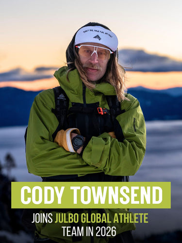 A man in a green jacket and white visor stands outdoors with arms crossed; text reads, Cody Townsend joins Julbo Global Athlete Team in 2026.