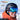 A person in a black helmet and ski goggles smiles outdoors with snowy mountains reflected in the goggles. Logos for Reactiv Photochromic and Super Flow Pro are visible.