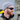 A man with a red beard, wearing a gray knit beanie, black hoodie, and Julbo-usa Montebianco 2 mountain sunglasses with removable side shields, smiles outdoors.