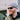 A man with a red beard wearing a gray knit beanie, a black hoodie, and a green vest smiles outdoors in Julbo Eyewear Montebianco 2.0 RX sunglasses.