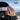 A person wearing a black hat and ski goggles with JULBO branding stands on a snowy mountain, adjusting their goggles. SUPER FLOW PRO and 90 days money back guarantee text is visible.