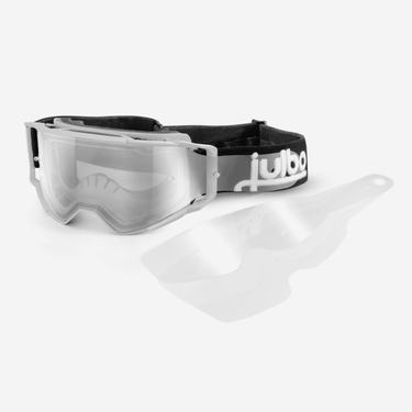 Julbo Eyewear clear motocross goggles with a black adjustable strap are shown alongside two Shuttle MTB Tear-off Lenses for quick lens changes and added protection.