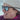Person wearing a beanie and sunglasses with a blurred background