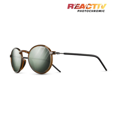 Round sunglasses with a translucent brown frame and photochromic lenses that darken when exposed to light, shown on a white background with the 'REACTIV PHOTOCHROMIC' logo in the top right. #color_translucent-brown-/-black-with-reactiv-1-3-glare-control-lens