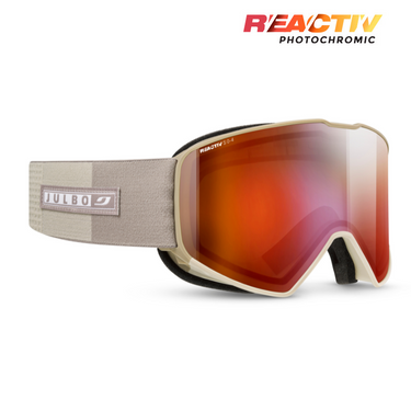 Beige Julbo Eyewear Cyrius X frameless ski goggles with a wide elastic strap and orange-tinted REACTIV photochromic lens, featuring REACTIV photochromic technology, shown on a white background. #color_champagne-with-reactiv-0-4-high-contrast-lens