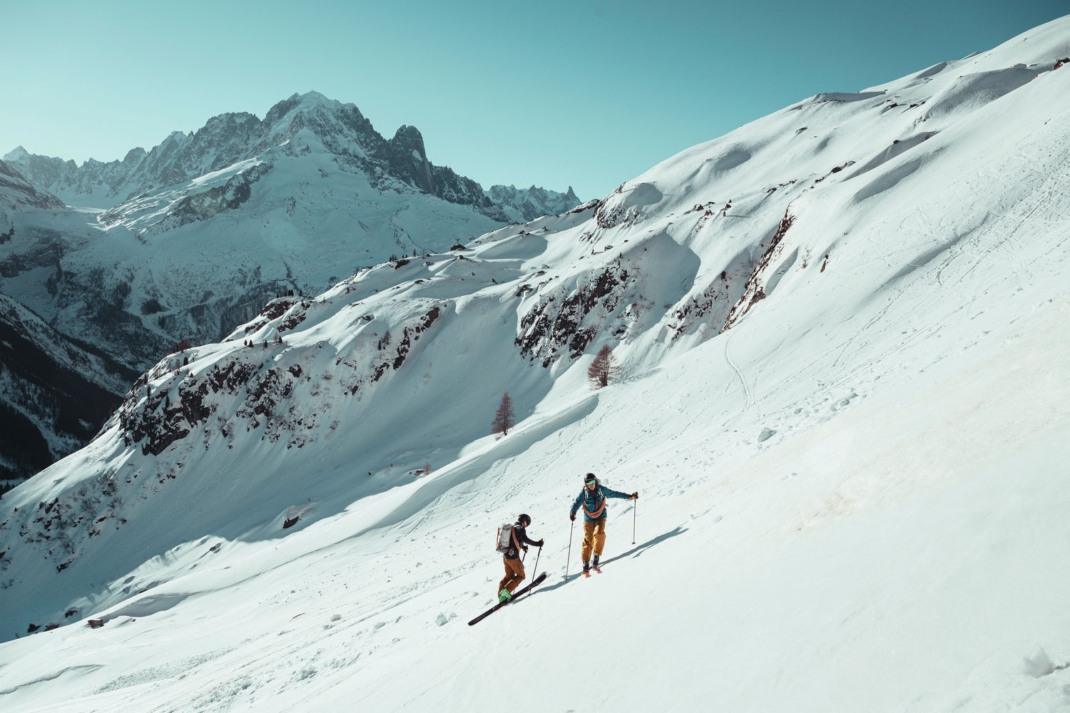 Two Backcountry Skiers skinning to the summit