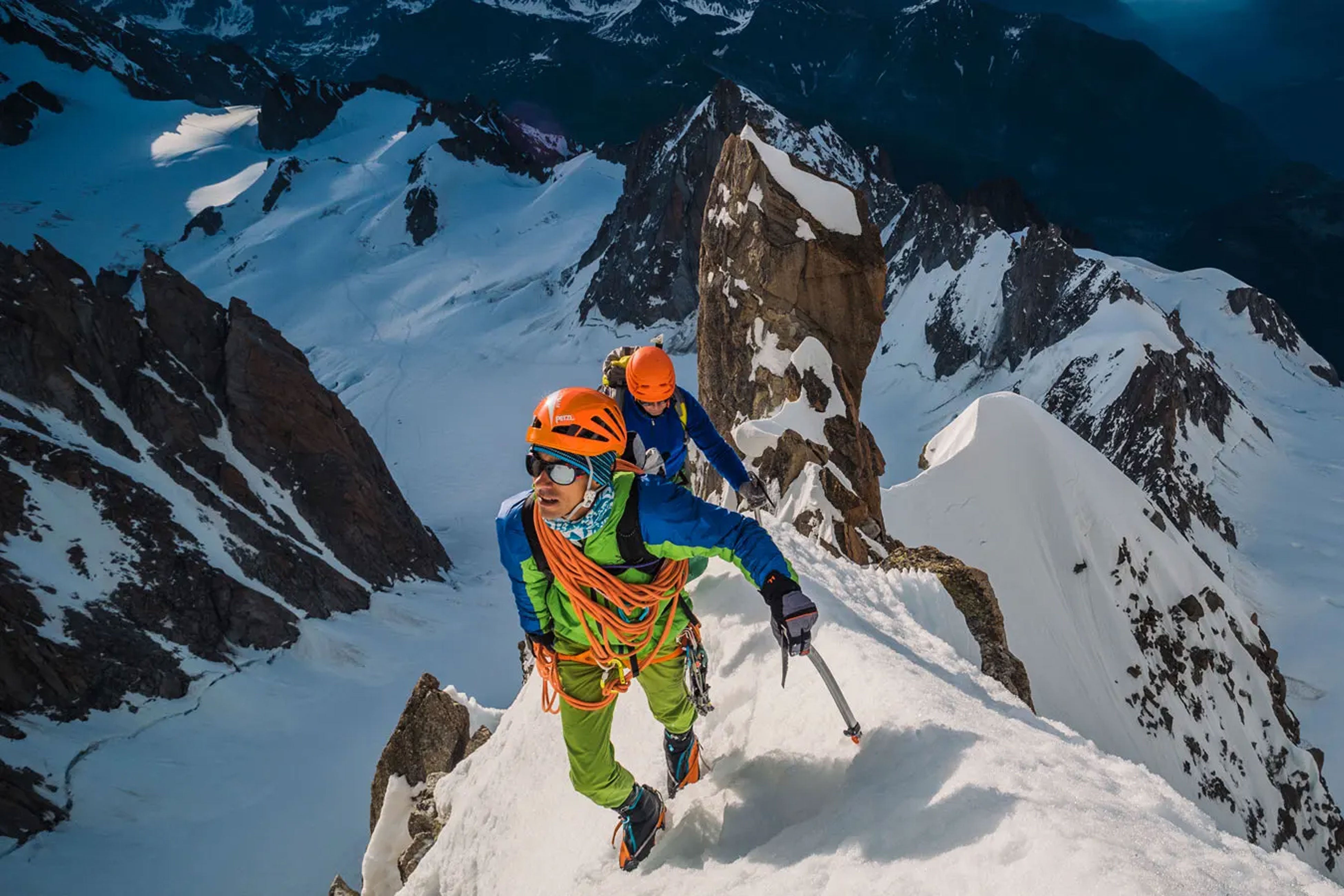 Alpinist Climbs to a mountain summit in his Julbo sunglasses