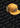 A mustard yellow corduroy cap with ear flaps and a JULBO logo patch, placed on a background patterned with repeating JULBO text.