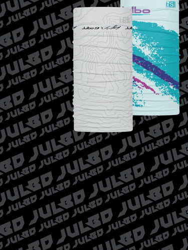 Two cylindrical neck gaiters with abstract designs are displayed against a black background featuring a repeating JULBO logo.