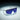 A pair of sunglasses with a metallic frame and large blue-tinted, single-lens design is displayed under focused lighting.