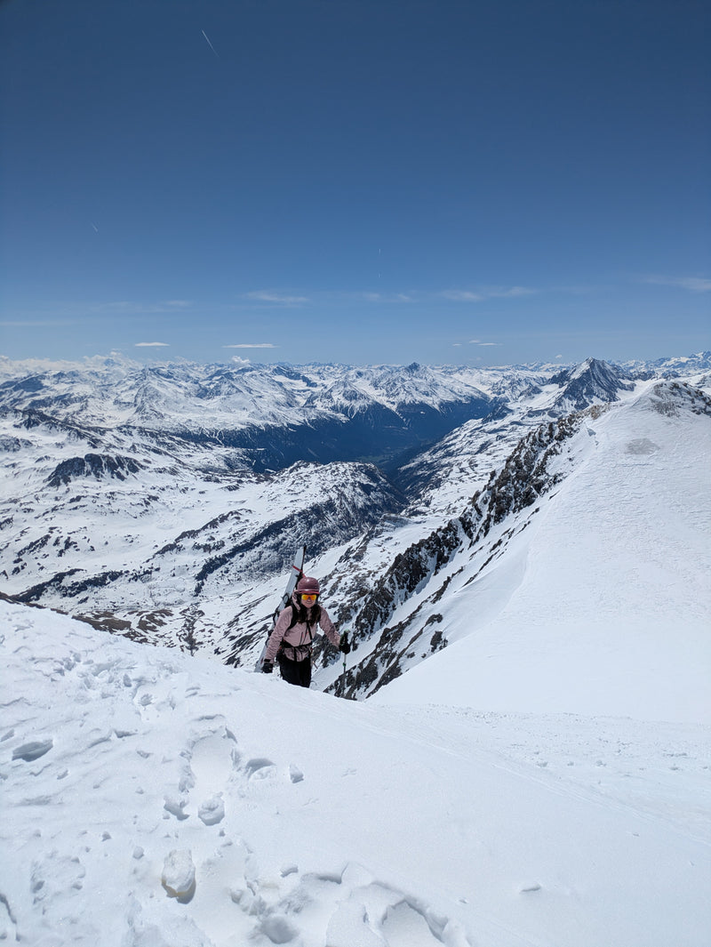 Woman climbing up a mountain while wearing Julbo Frequency sunglasses