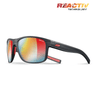 The Julbo-usa Renegade sunglasses feature black frames with red accents, mirrored multicolor REACTIV photochromic lenses, a "REACTIV Technology" logo on the top right lens, and deliver wide-angle vision for any adventure. #color_black-red-with-reactiv-1-3-light-amplifier-lens