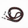 A black and red Julbo Eyewear Braided Cord eyeglass strap with metal clips and a branded tag is coiled on a white background.