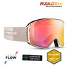 Beige and white Julbo Eyewear Launcher ski goggles with cylindrical XL REACTIV pink photochromic lens, shown with SuperFlow Pro anti-fog, Gearhead Top Picks, and Blister Best of 2025 award badges.