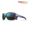 A pair of blue Julbo-usa Monterosa 2 sunglasses with mirrored photochromic lenses, REACTIV logo, branding on the temple, and an adventure-ready frame featuring removable side shields. #color_iridescent-purple-with-reactiv-2-4-lens