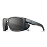 Julbo Eyewear Shield RX: Black sport sunglasses with rectangular lenses, side shields, and blue accents. Enjoy optical precision with REACTIV photochromic Rx lenses for the ultimate prescription sunglasses, shown on a white background. #color_black-/-blue