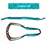 The Julbo Eyewear Neoprene Sunglass Strap in turquoise features a black and yellow lightning bolt pattern, universal fit, and waterproof design. Shown on black sunglasses and also displayed separately. #color_julbo-neoprene-sunglass-strap-blue-lightning