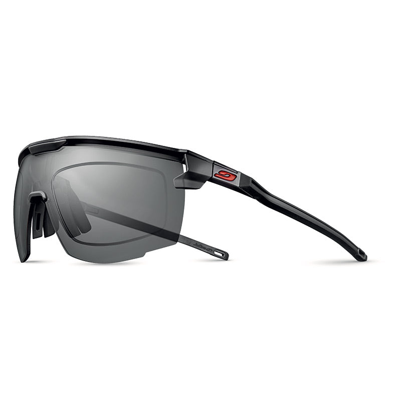 Julbo Eyewear’s Ultimate RX sports sunglasses feature a black frame, rectangular gray lenses, a red logo on the temple, and panoramic lens geometry for enhanced vision, shown against a white background. #color_black-/-red